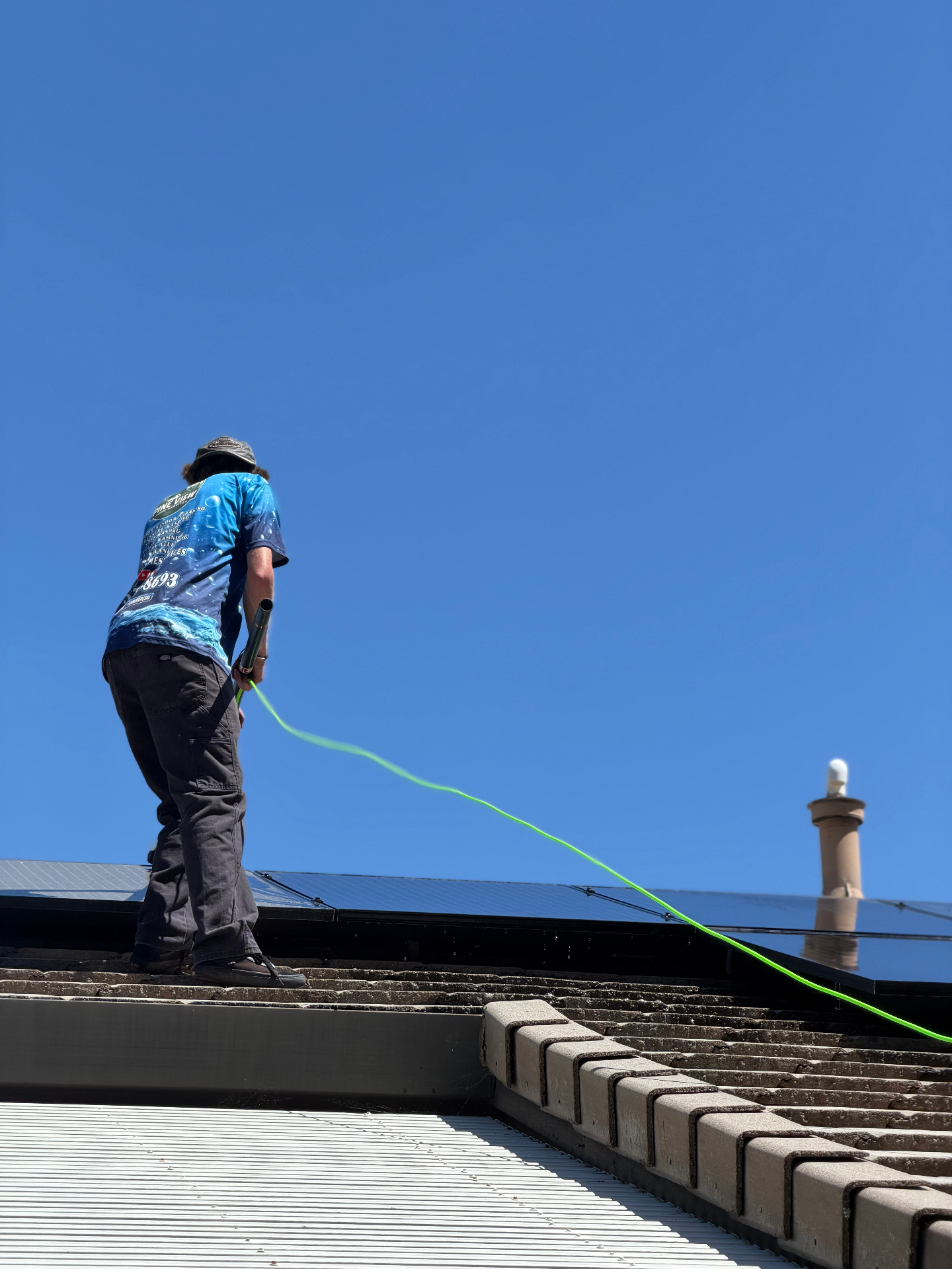 Pure-water rinse on tile-roof solar array